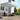 Grey manual retractable patio awning extended above outdoor seating area